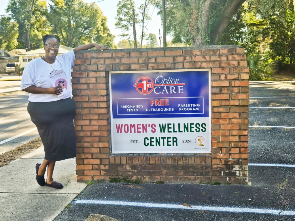 Alicia Hurtt Standing in front of Women's Wellness Center