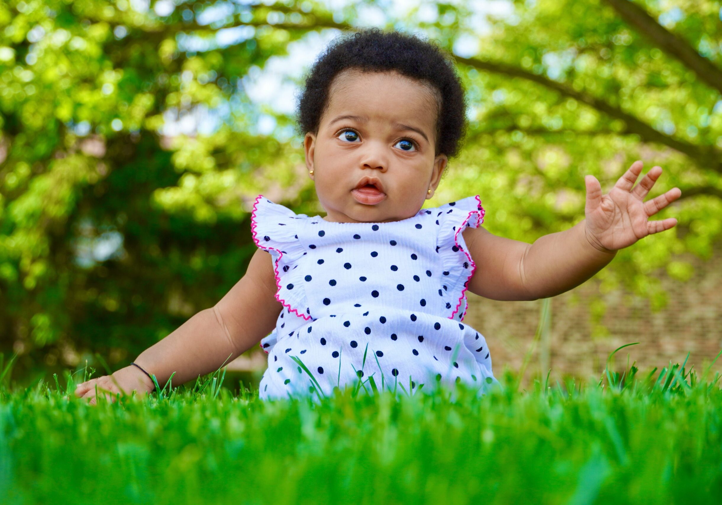 Baby sitting in the grass.